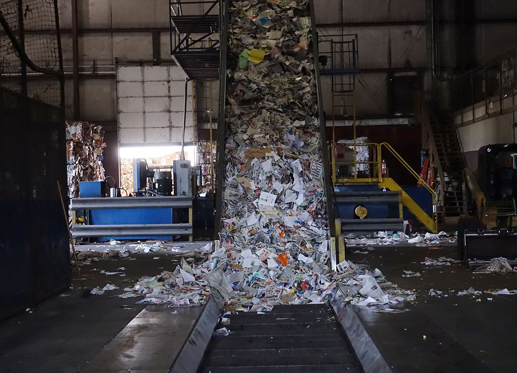 The main conveyor belt holds a mass of recyclables